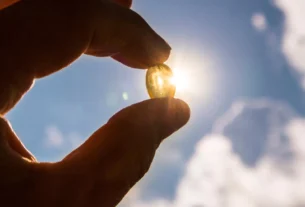 hand holding vitamin d pill in sunshine